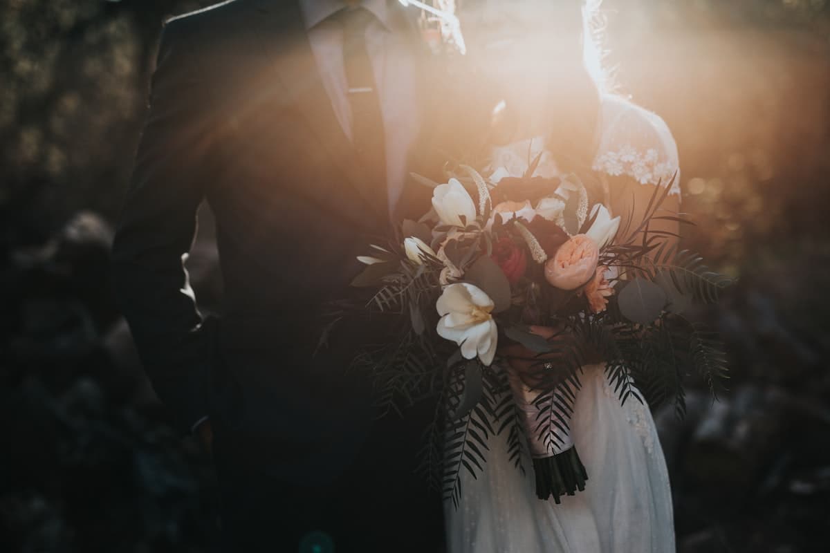 Bride and groom celebrating with flower petals