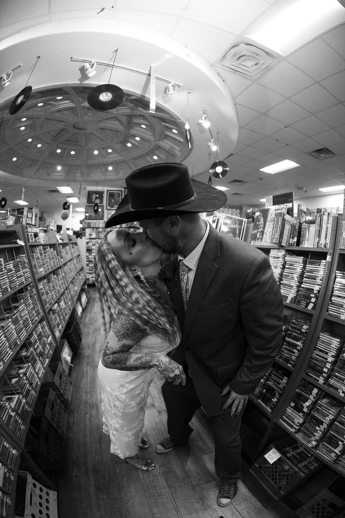 Cinematic black and white wedding photo in a Las Vegas record store