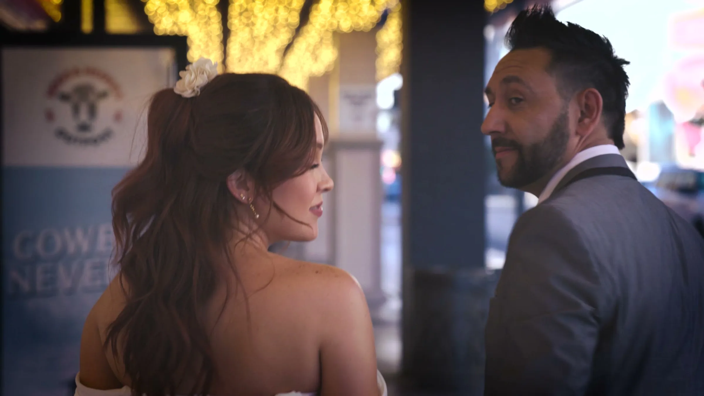 A bride glancing back over her shoulder on Fremont Street